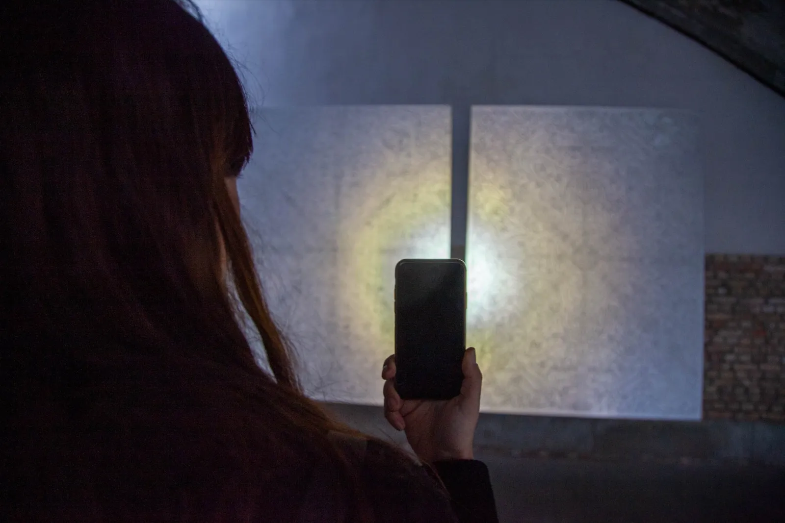 FLOWSTATE — a visitor reveals a retroreflective work with a handheld light