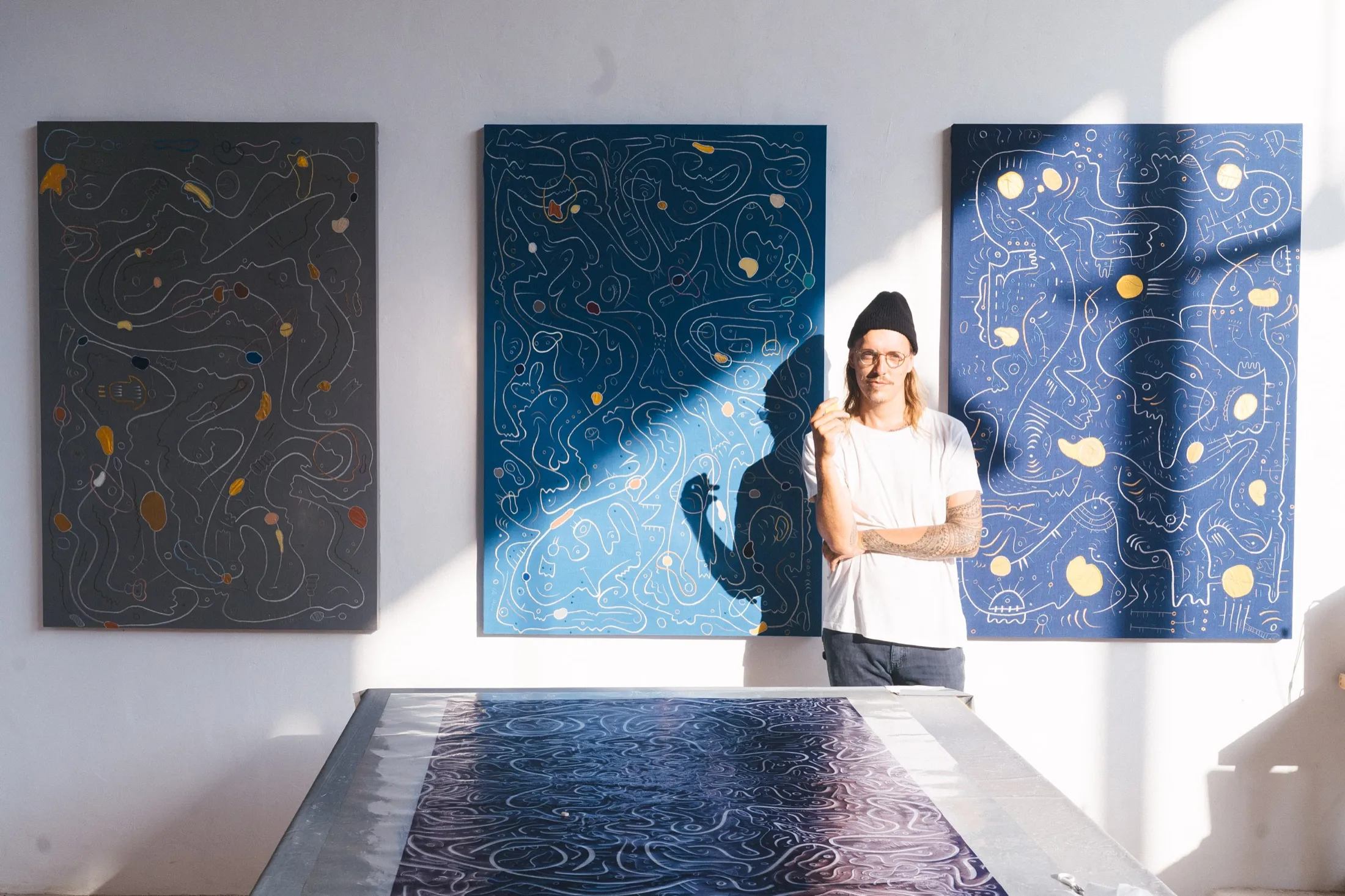 Ole Ukena with textile paintings in the studio
